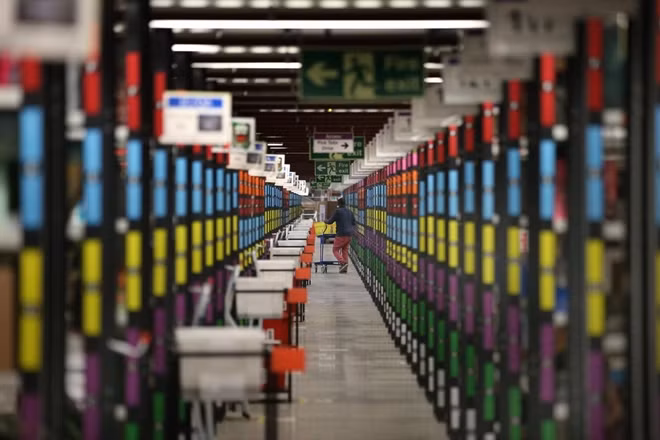 A worker retrieves goods from shelves at Amazon's warehouse on December 5, 2014 in Hemel Hempstead, England Peter Macdiarmid/Getty Images