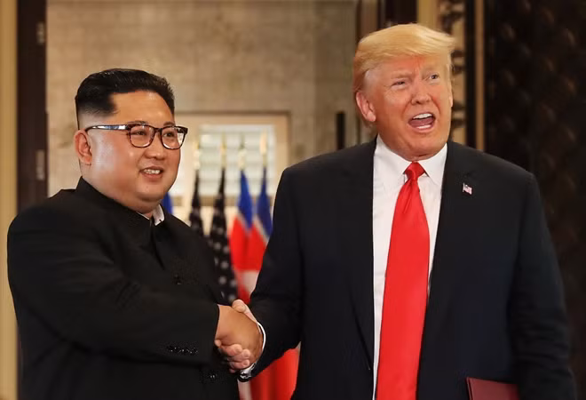 Trump and Kim shake hands after signing documents during a summit in Singapore. Reuters