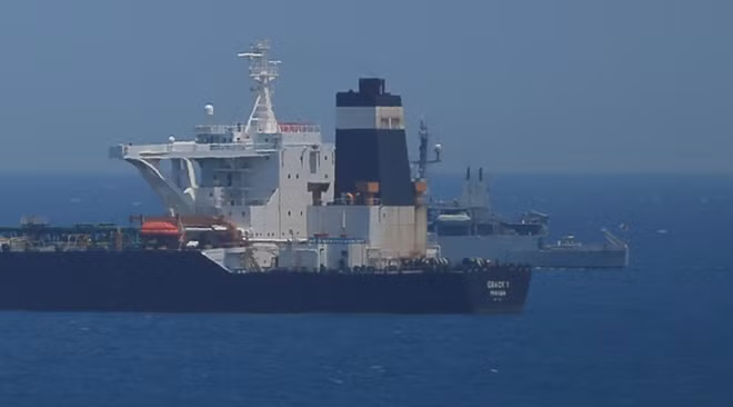 A British Royal Navy patrol vessel guards the oil supertanker Grace 1, that's on suspicion of carrying Iranian crude oil to Syria, as it sits anchored in waters of the British overseas territory of Gibraltar, historically claimed by Spain, July 4, 2019. REUTERS/Jon Nazca