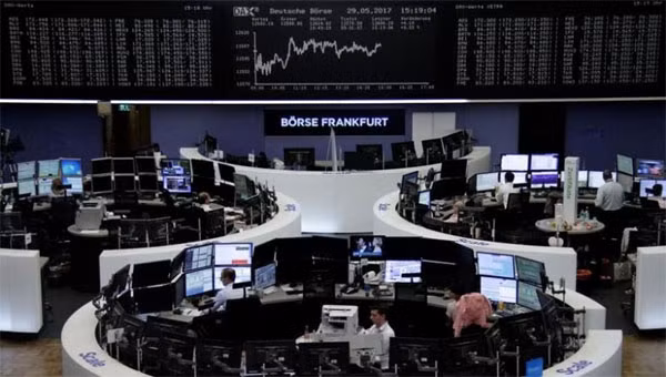 Traders work in front of the German share price index, DAX board, at the stock exchange in Frankfurt, Germany, May 29, 2017.