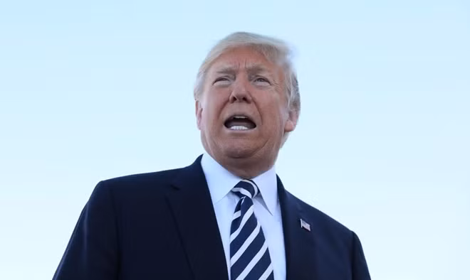 U.S. President Donald Trump speaks with reporters before departure from Elko Regional Airport in Elko, Nevada, U.S., October 20, 2018. REUTERS.