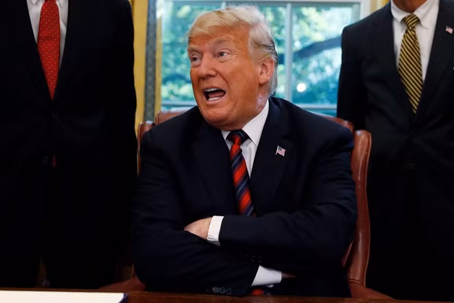 U.S. President Donald Trump talks to reporters about the killing of journalist Jamal Khashoggi in Turkey during a bill signing ceremony at the White House in Washington, U.S., October 23, 2018. REUTERS/Leah Millis