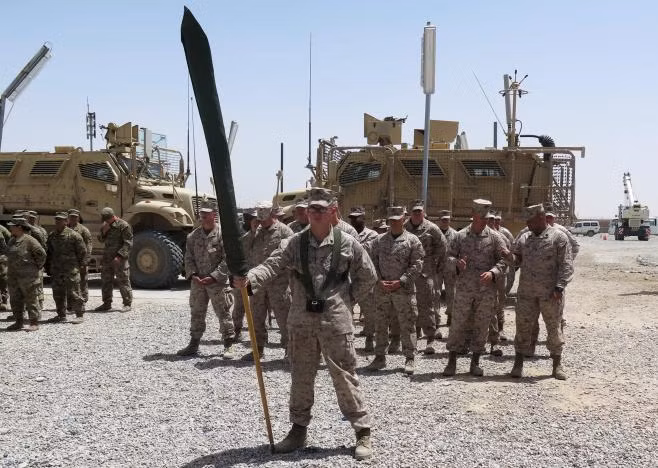 U.S. Marines stand at attention during a transfer of authority ceremony at Shorab camp, in Helmand province, Afghanistan April 29, 2017. REUTERS/James Mackenzie