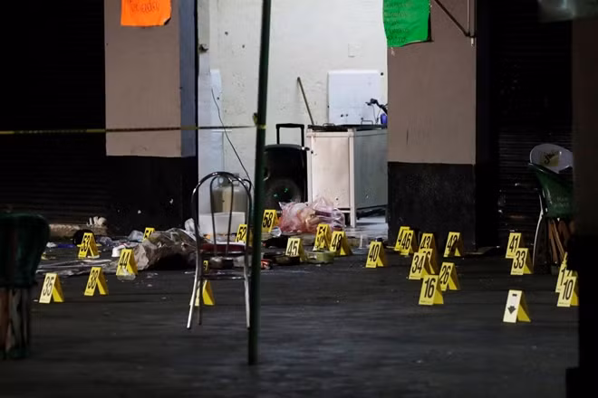 Evidence markers are seen at a crime scene where three men were gunned down by unknown assailants at an intersection on the edge of tourist Plaza Garibaldi in Mexico City, Mexico September 14, 2018. REUTERS/Henry Romero