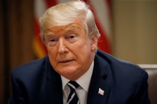 U.S. President Donald Trump reds from prepared remarks as he speaks about his summit meeting with Russia's President Vladimir Putin at the start of a meeting with members of the U.S. Congress at the White House in Washington, July 17, 2018. REUTERS