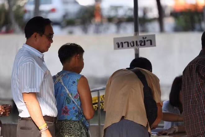 Thailand's Prime Minister Prayuth Chan-ocha (L) prepares to vote in the general election at a polling station in Bangkok, Thailand, March 24, 2019. REUTERS