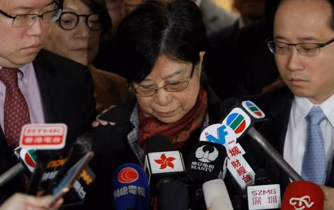Selina Tsang, wife of former Hong Kong Chief Executive Doanld Tsang, accompanied by sons Simon (L) and Thomas, meets journalists at the High Court in Hong Kong, China February 22, 2017. REUTERS/Bobby Yip