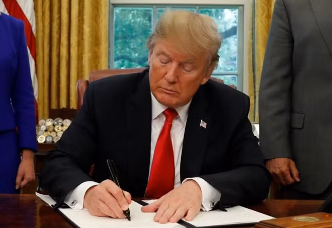 U.S President Donald Trump signs an executive order on migration policy. Reuters