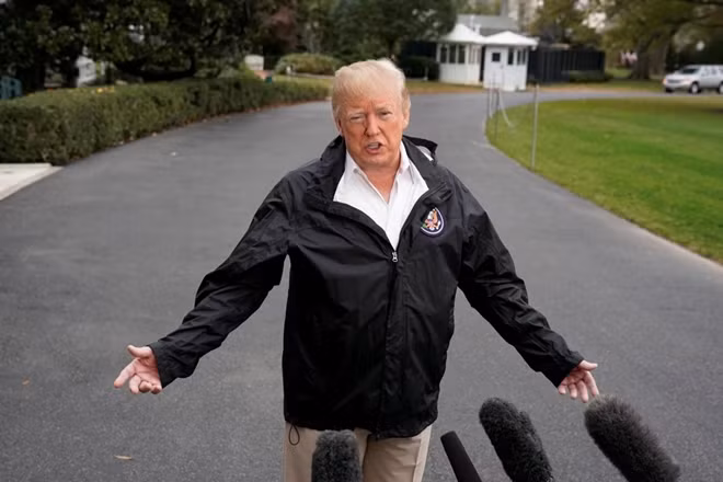 U.S. President Donald Trump talks to the media on the South Lawn of the White House in Washington, U.S., before his departure to California, November 17, 2018. REUTERS