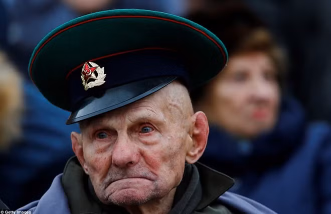 A Russian veteran watches the parade marking the anniversary, when Soviet soldiers marched towards the front lines, at the Red Square in Moscow.