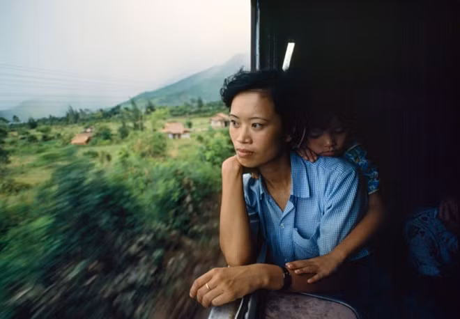 One of Catherine's favorite photos that she took in Vietnam. "WOMAN ON THE TRAIN, 1990 – In Central Vietnam, Tran Thi Diep, a schoolteacher from Hanoi, rides the Ho Chi Minh City-Hanoi train, also known as the Reunification Express".