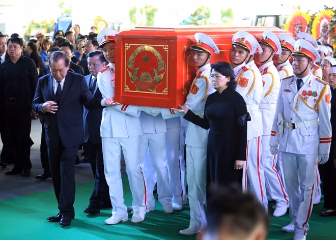 Acting President Dang Thi Ngoc Thinh and Permanent Deputy Prime Minister Truong Hoa Binh join hands to carry President Tran Dai Quang’s coffin in his homeland.