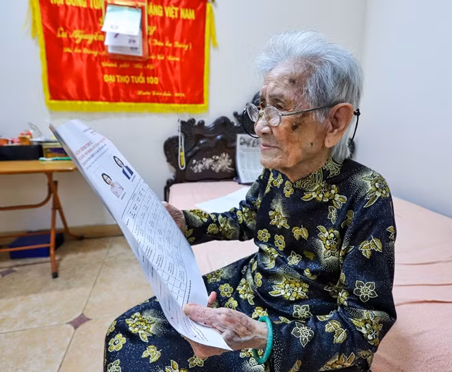 Ms. Tam reading through the bibliographies of the candidates for the 15th National Assembly and People’s Councils at all levels for the 2021-2026 term at home.