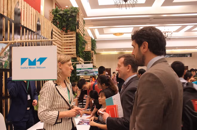 French Ambassador exchanging information with a representative of a French university. French Ambassador exchanging information with a representative of a French university.