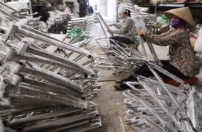 Workers make bicycle frames at a small-sized enterprise in Thai Binh province.