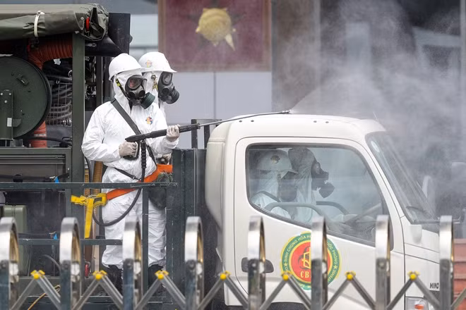 Soldiers from the Vietnamese army’s chemical division disinfect the National Hospital for Tropical Diseases in Dong Anh district.
