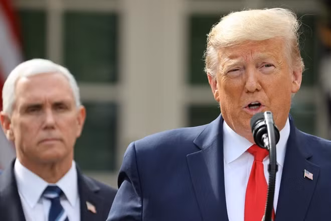 U.S. President Donald Trump declares the coronavirus pandemic a national emergency as Vice President Mike Pence listens during a news conference in the Rose Garden of the White House in Washington, U.S., March 13, 2020. REUTERS/Jonathan Ernst