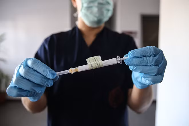 A healthcare worker with a syringe of the vaccine developed by Pfizer and BioNTech at a hospital in Ankara, Turkey on Oct. 27, 2020. Getty Images.