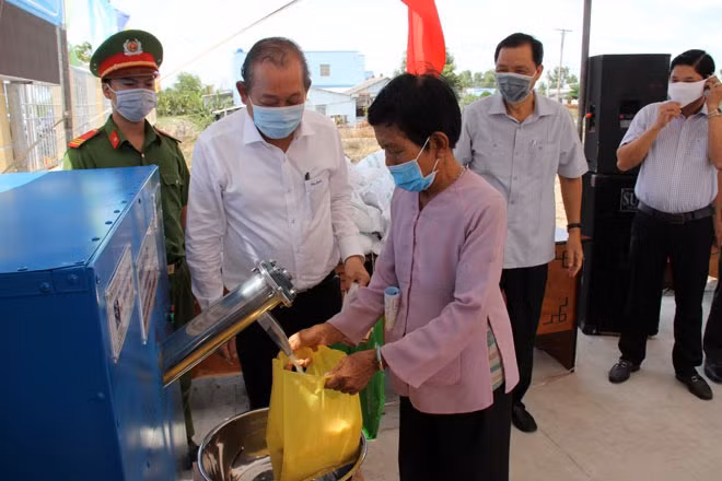 Deputy PM Truong Hoa Binh witnesses local people getting rice from a rice ATM. Deputy PM Truong Hoa Binh witnesses local people getting rice from a rice ATM.