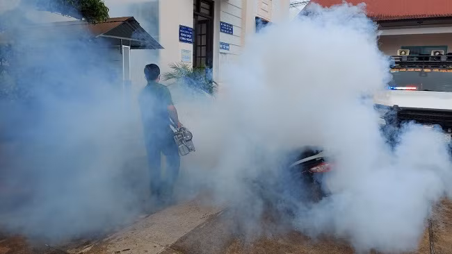 A policeman disinfecting an area in Da Nhim.