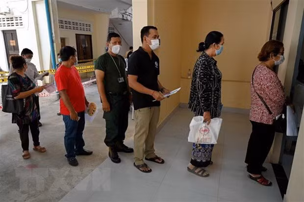 People wait in line for COVID-19 vaccinations in Phnom Penh, Cambodia. (Photo: AFP/VNA)
