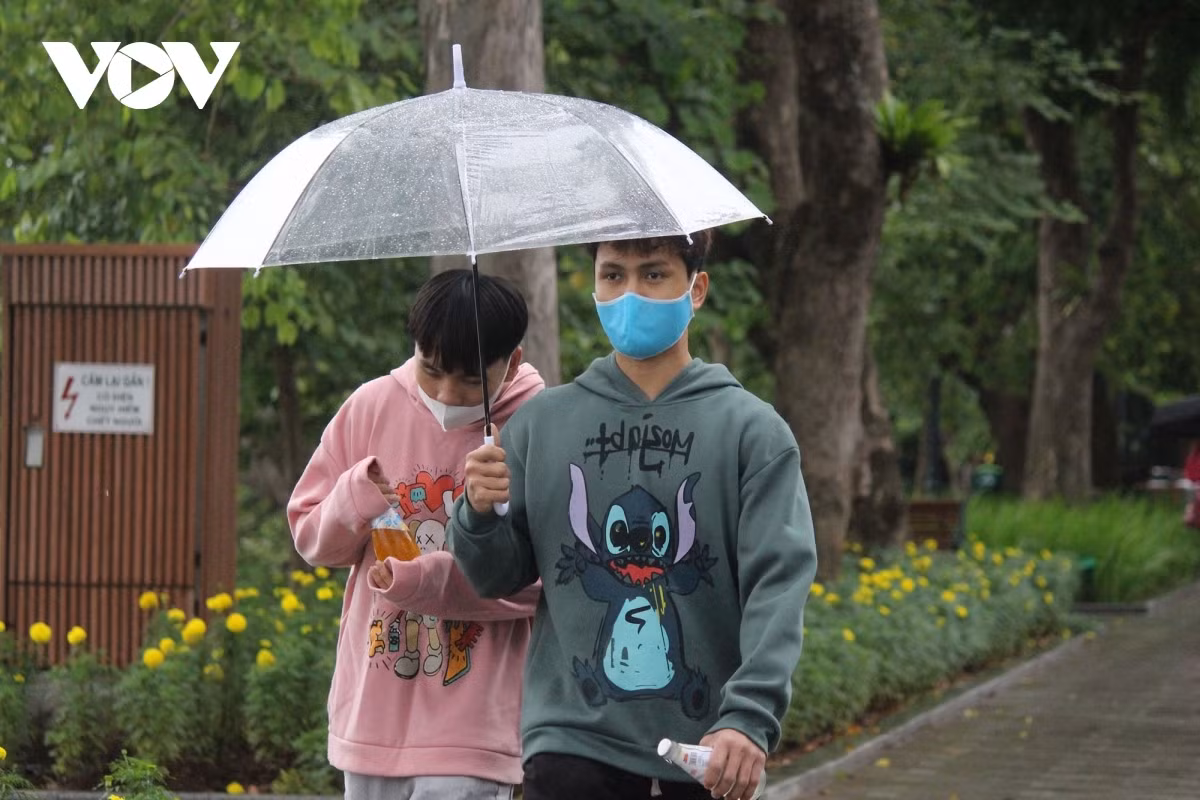 Local people wrap up tight in jackets whilst wearing facemasks, in line with COVID-19 prevention and control measures.