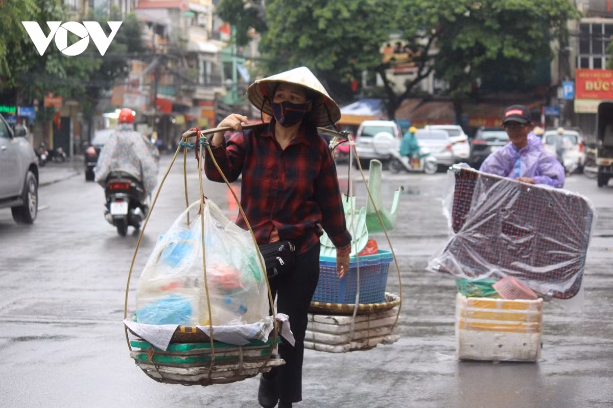When the city moves into a new normal post pandemic, street vendors like the woman in the photo work hard to earn a living.