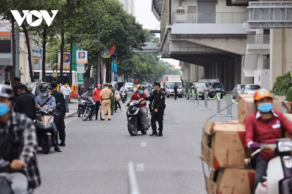 Vehicles are stopped to have their travel permits and identity cards checked.