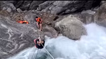 Local police successfully rescue foreign tourist stuck at a fast-running waterfall