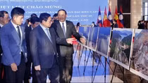 PMs of Vietnam, Laos visit photo exhibition on achievements of economic ties