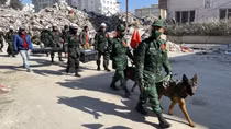 Vietnamese military rescuers position three quake victims in Turkey